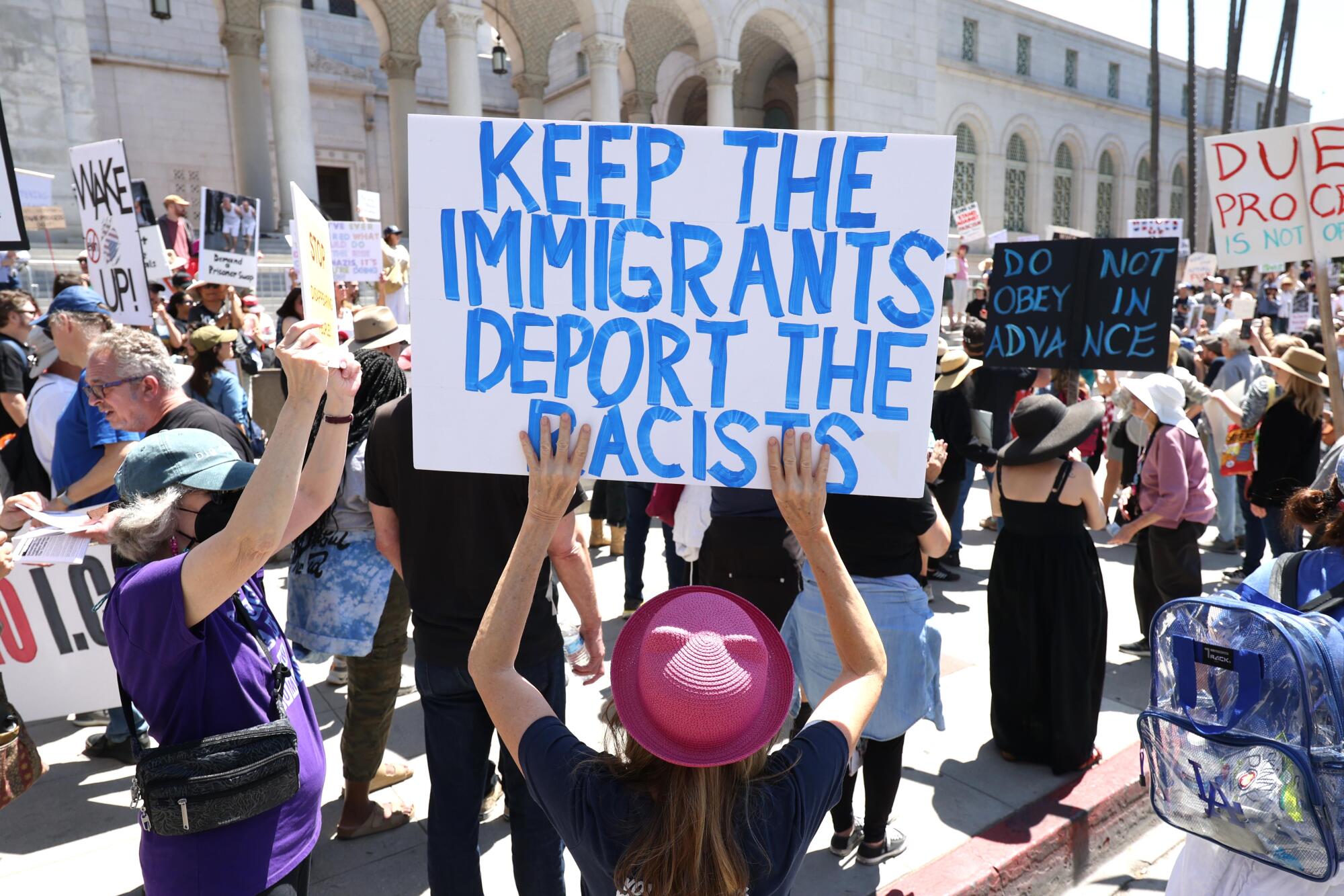 Protesters rally for immigrant rights, to stop mass deportations and decrying what they see as threats to Democracy