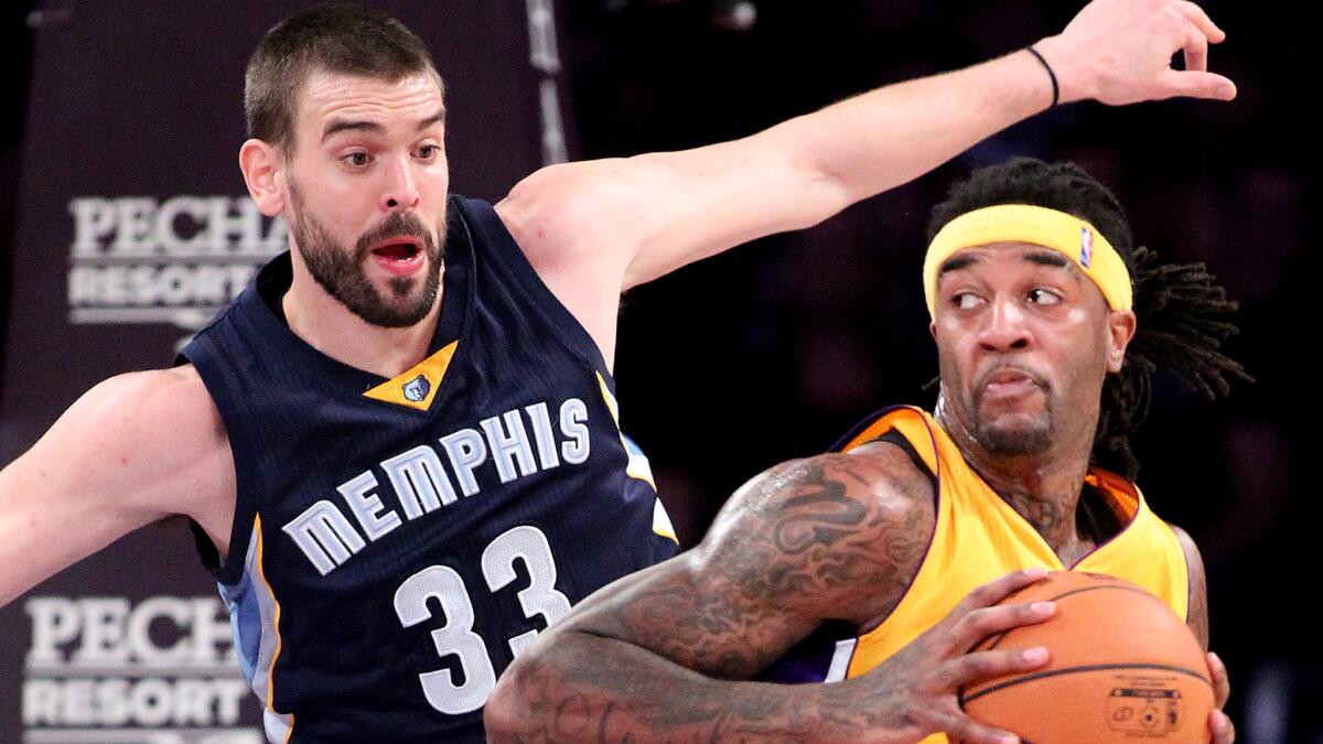 Lakers forward Jordan Hill, right, works in the post against Memphis Grizzlies center Marc Gasol during the first half of a game on Nov. 26 at Staples Center.