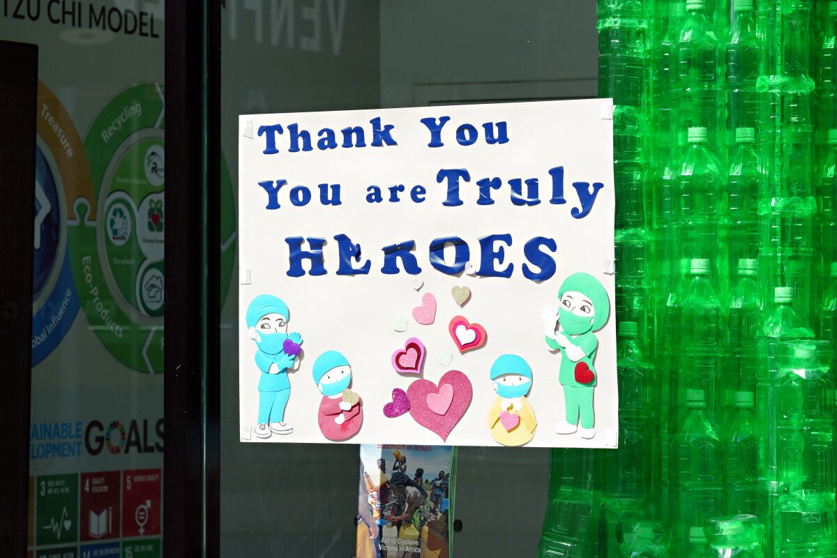 A storefront sign in New York City thanks medical workers. 