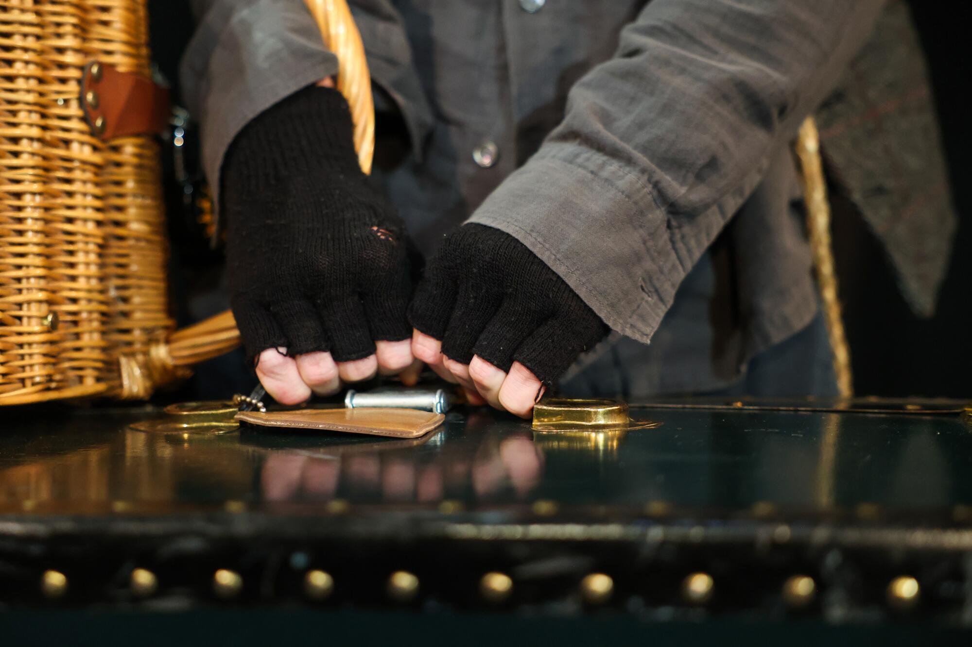 Actor Mason Conrad holds a large suitcase while acting in "Escape from Godot."