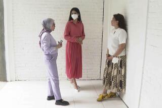 In this image made from video, contestant of Miss Universe Indonesia Priskila Ribka Jelita, center, talks with her mother, Maria Napitupulu, right, and lawyer Melisa Anggraini during an interview with the Associated Press Television in Jakarta, Indonesia, Tuesday, Aug. 15, 2023. The lawyer of a number of contestants of Miss Universe Indonesia pageant said Tuesday they have filed complaints with police, accusing local organizers of sexual harassment. (AP Photo/APTN)