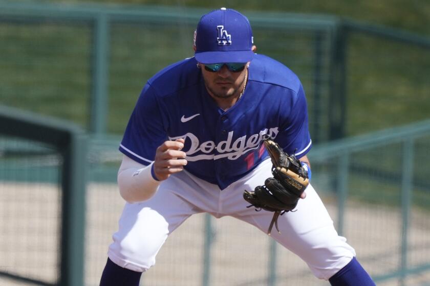 Los Angeles Dodgers shortstop Miguel Rojas warms up during the third inning.