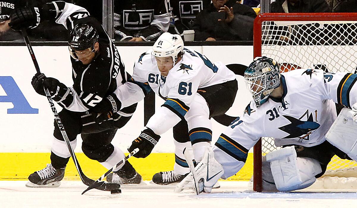 Kings forward Marian Gaborik brings the puck into the crease against the defense of Justin Braun and goalie Antti Niemi during a playoff game against the Sharks last spring.