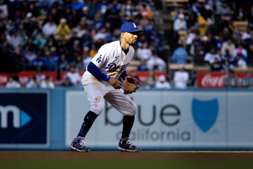 LOS ANGELES, CA - APRIL 14, 2024: Los Angeles Dodgers shortstop Mookie Betts (50) sets himself on defense against the San Diego Padres at Dodger Stadium on April 14, 2024 in Los Angeles, California.(Gina Ferazzi / Los Angeles Times)