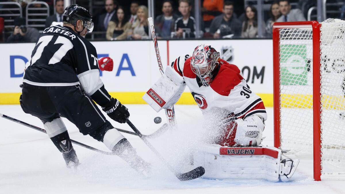 Carolina Hurricanes goalie Cam Ward, right, makes a save on a shot by Kings center Jeff Carter during the Kings' 3-2 win at Staples Center on Nov. 20.