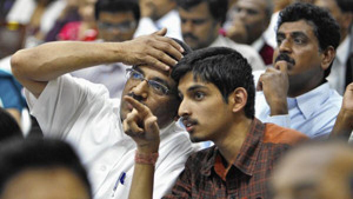 A college applicant and his father in Bangalore, India, watch a screen displaying seats allotted to students after the son passed an entrance test in 2011.