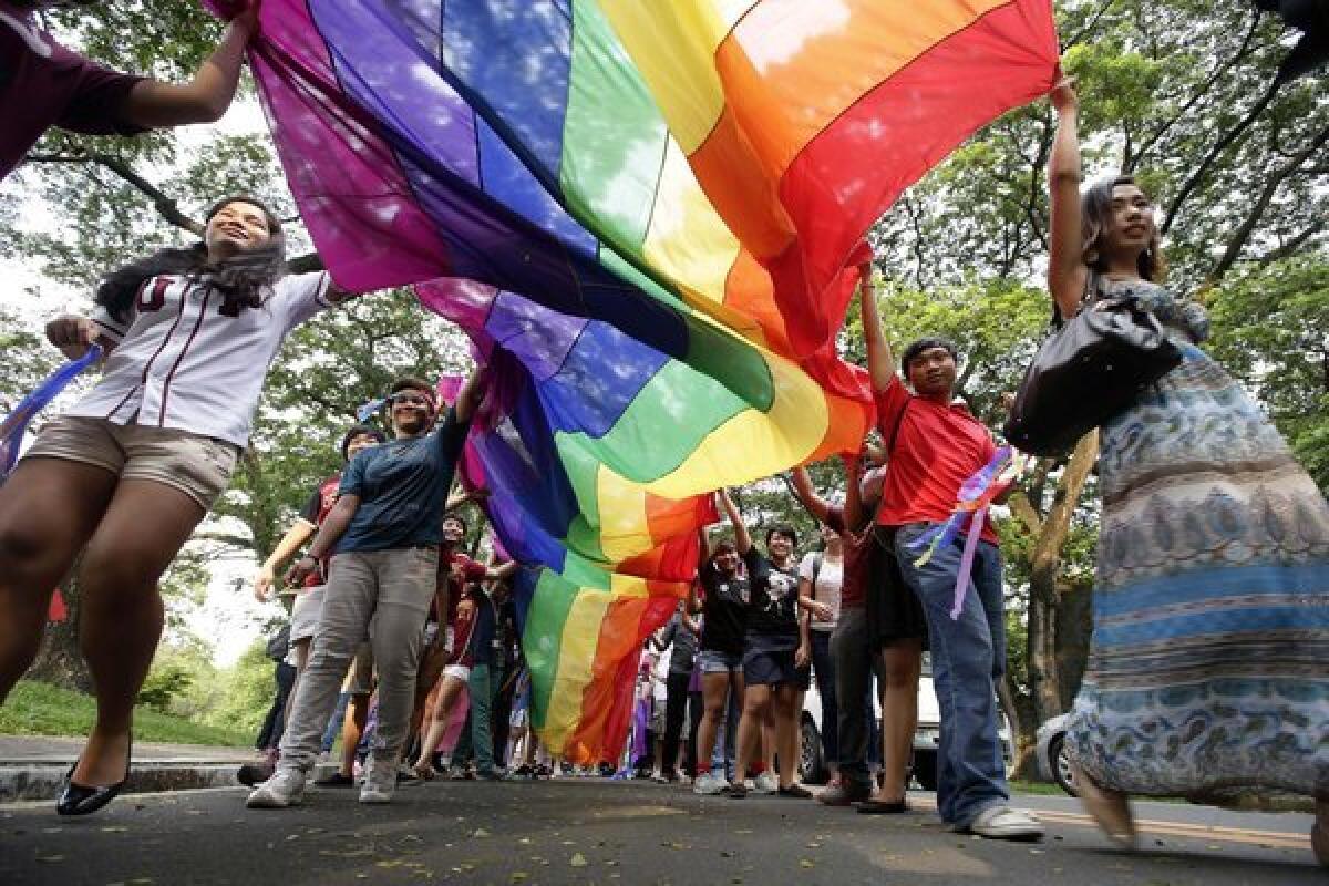 Students march in a gay pride parade in the Philippines last month. A U.S. appeals court panel ruled Wednesday that a gay man who came to the United States from the Philippines could not be deported because he faced bias in his home country.