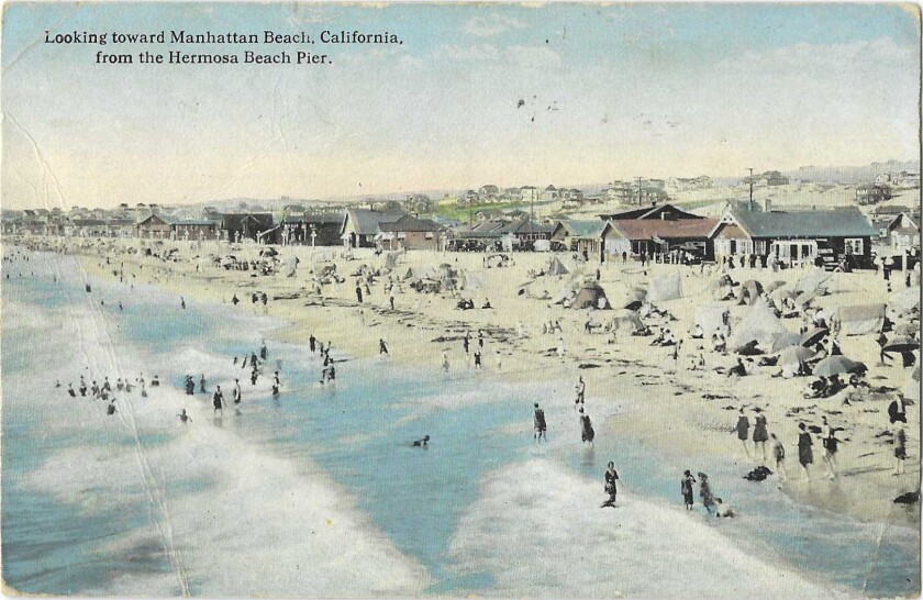 Beachgoers in the surf as seen from the Hermosa Beach Pier