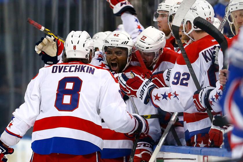 Capitals right wing Joel Ward is surrounded by teammates after scoring with less than two seconds left in the third period to give Washington a 2-1 win over the Rangers in Game 1 on Thursday night in New York.