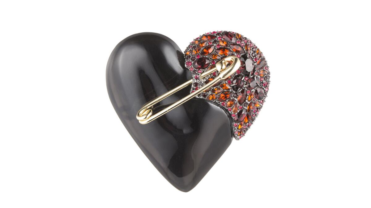 Alexis Bittar crystal-encrusted Black Cherry Broken Heart Pin with golden pin detailing, $295 at Alexis Bittar boutiques in Venice, Malibu and West Hollywood, alexisbittar.com.