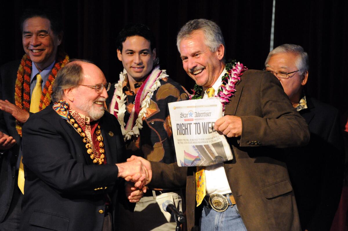 Hawaii Gov. Neil Abercrombie, left, shakes hands with former Sen. Avery Chumley after Abercrombie signed a bill legalizing gay marriage in Hawaii.