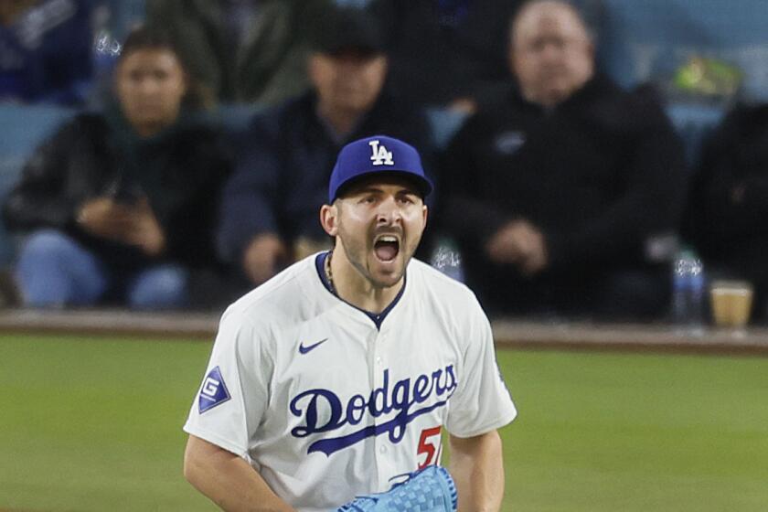 Dodgers pitcher Alex Vesia shouts as the Giants' Austin Slater flies out to in the sixth inning at Dodger Stadium 