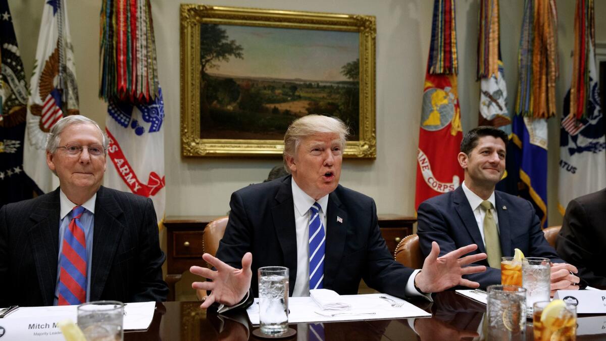 President Donald Trump, flanked by Senate Majority Leader Mitch McConnell of Ky., left, and House Speaker Paul Ryan of Wis., speaks in the White House in Washington on March 1.