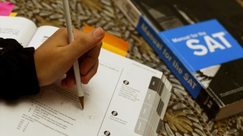 A student takes the SAT test in a large book with multiple choice questions. 