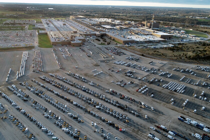 In this aerial photo, a General Motors assembly plant is seen at top right while mid-sized pickup trucks and full-size vans currently produced at the plant are seen in a parking lot outside Wednesday, March 24, 2021, in Wentzville, Mo. U.S. industrial production increased for a second straight month as more factories came online after being shutdown by winter ice storms. Industrial production — which includes output at factories, mines and utilities — rose 0.7% in April, down from a sharp gain of 2.4% drop in March, the Federal Reserve reported Friday, May 14. (AP Photo/Jeff Roberson)