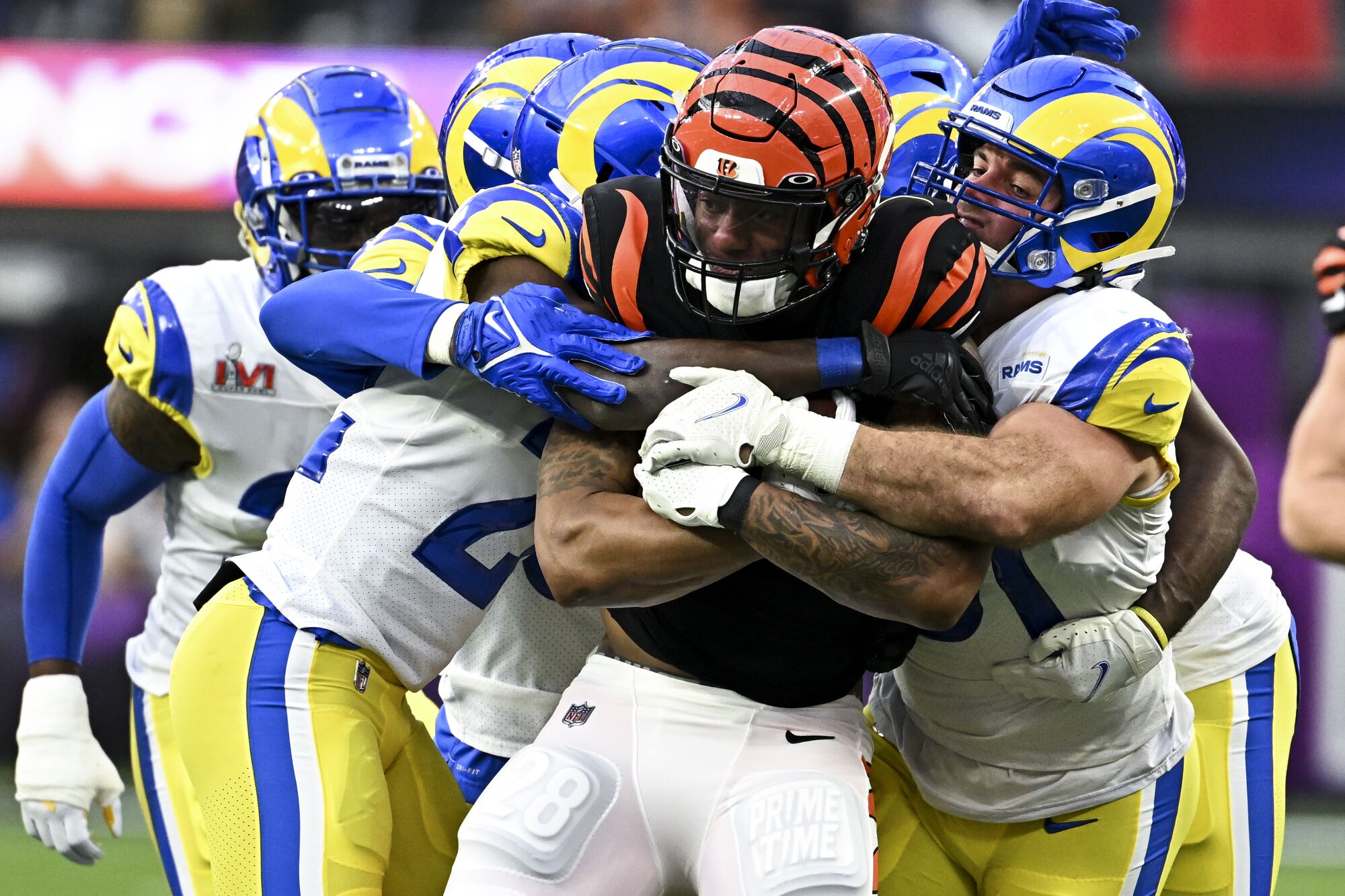  Rams defenders gang tackle Cincinnati Bengals running back Joe Mixon.
