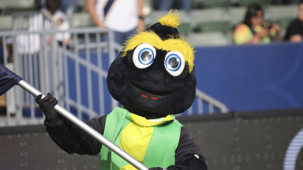 The Los Angeles Galaxy mascot Cozmo waves a victory flag after an MLS soccer game against the San Jose Earthquakes.