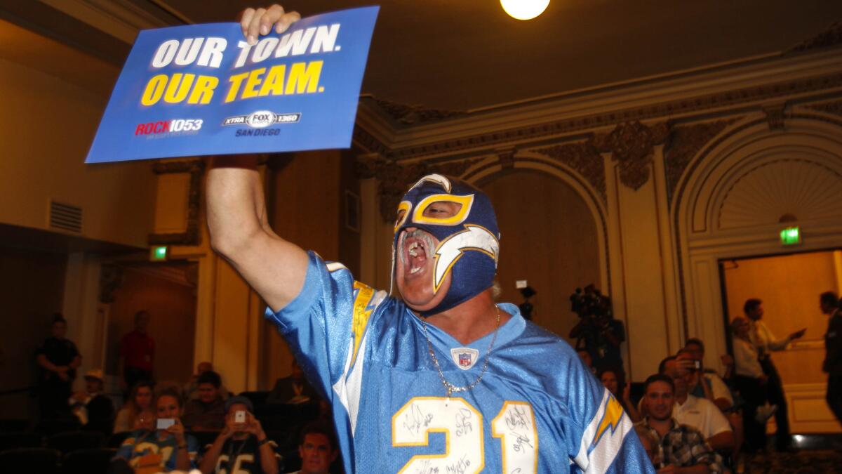 San Diego Chargers fan Renan Pozo, also known as "The Mask," fires up Chargers fans before the start of an NFL hearing about possible relocation to L.A.