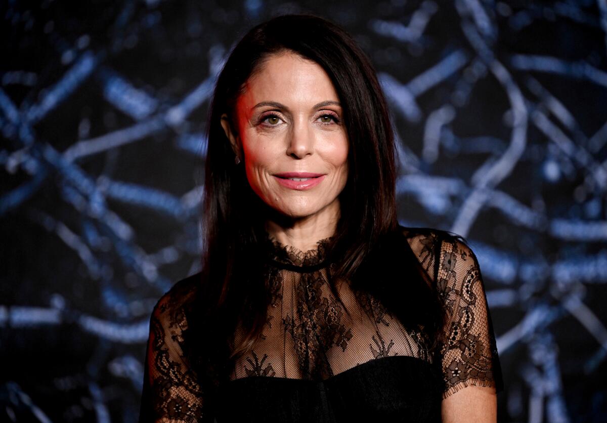 A headshot of Bethenny Frankel in a black lace top.