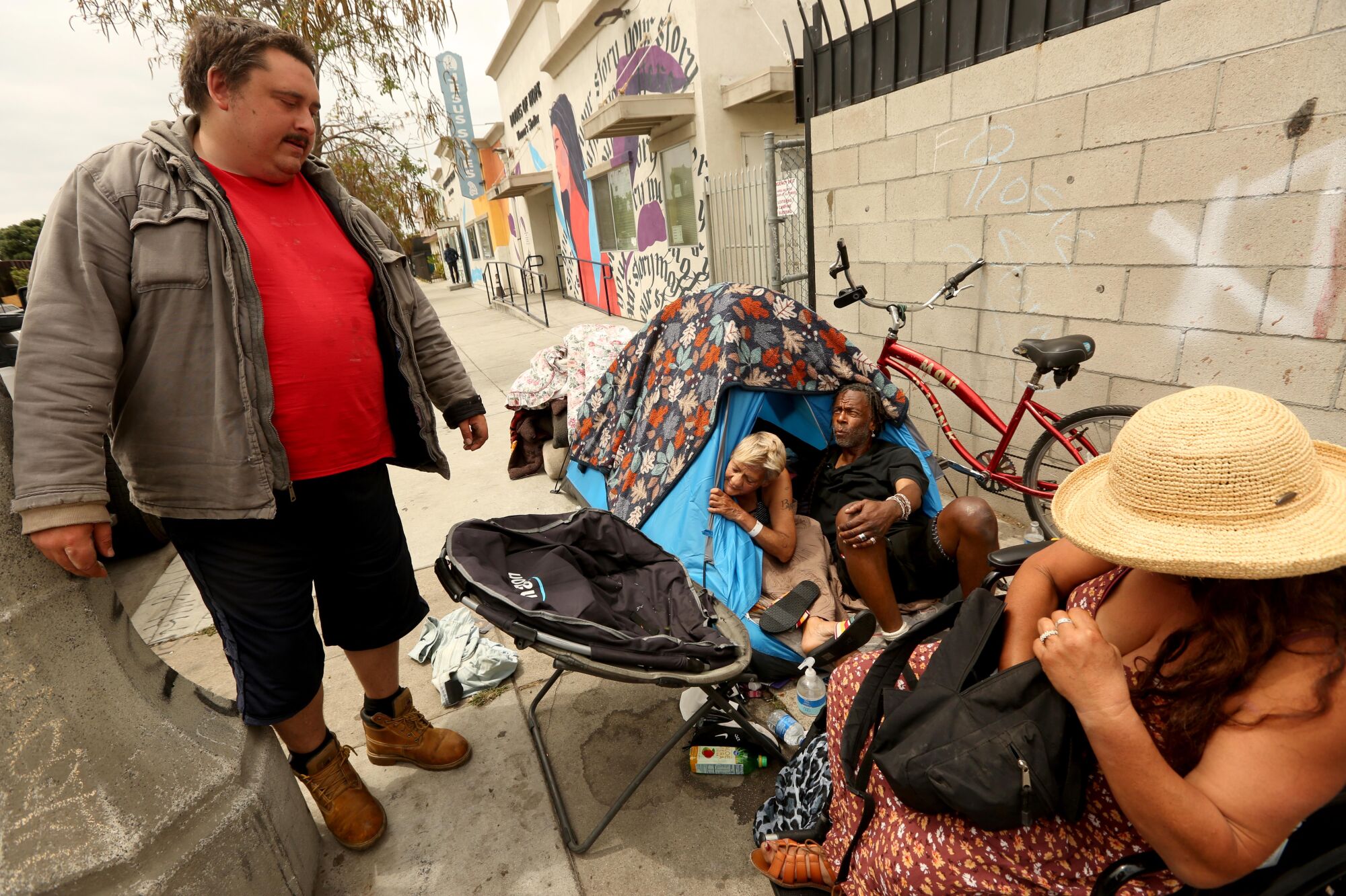 From left, Andrew Truelove talks with Camille Nieto, Cyrus Baker and Gitta Adam on a sidewalk in Wilmington.