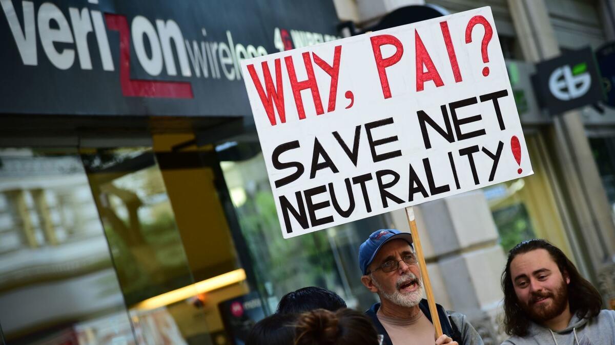 A small group of protestors supporting net neutrality protest against a plan by Federal Communications Commission head Ajit Pai, during a protest outside a Verizon store on Dec. 7 in Los Angeles.