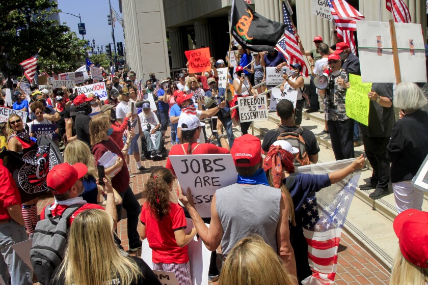 Hundreds of protesters gathered in downtown San Diego to demand that California reopen on May 1, 2020 in San Diego, California.