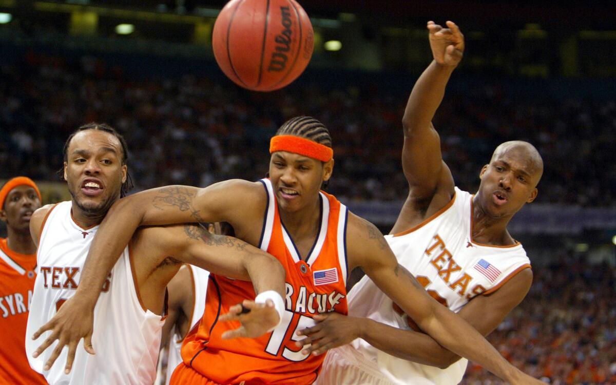 Carmelo Anthony, center, playing for Syracuse, with Texas' James Thomas and Sydmill Harris in 2003.