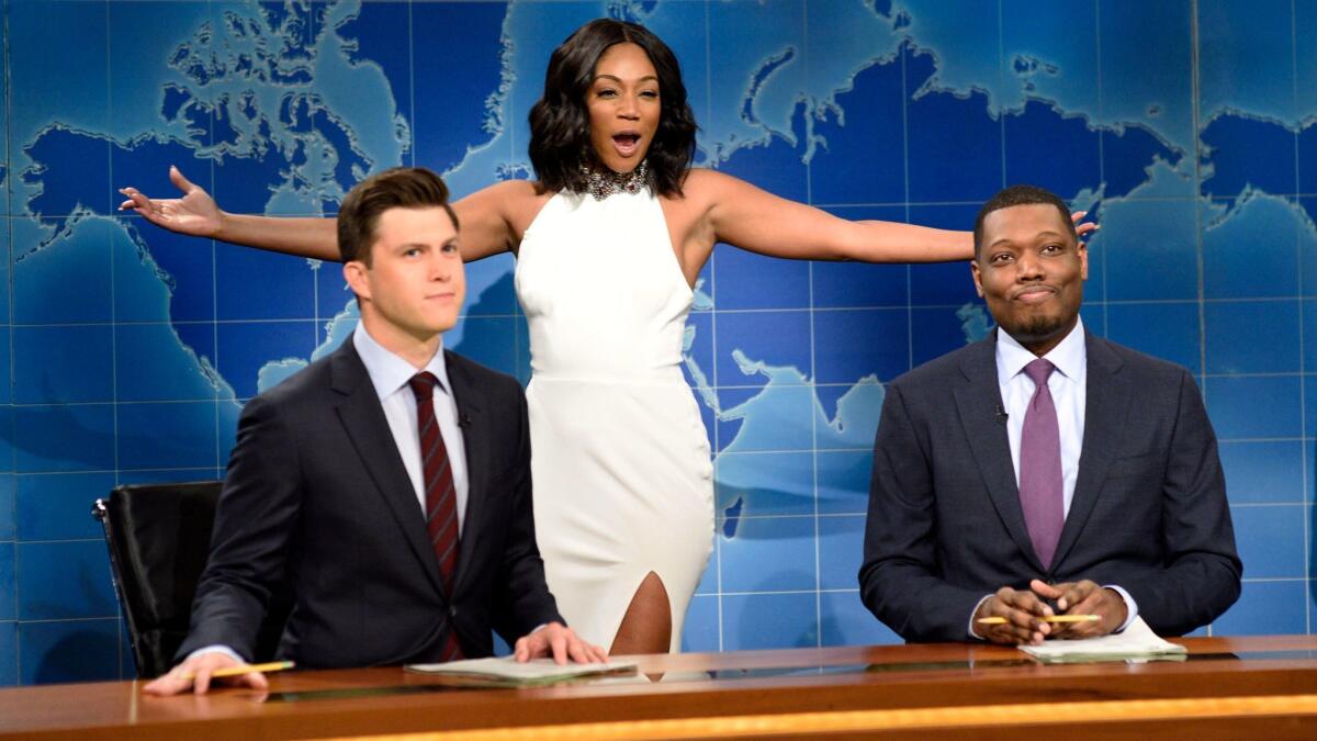 Comedian and actress Tiffany Haddish, center, with Colin Jost, left, and Michael Che during the "Weekend Update" sketch on "Saturday Night Live," in New York.