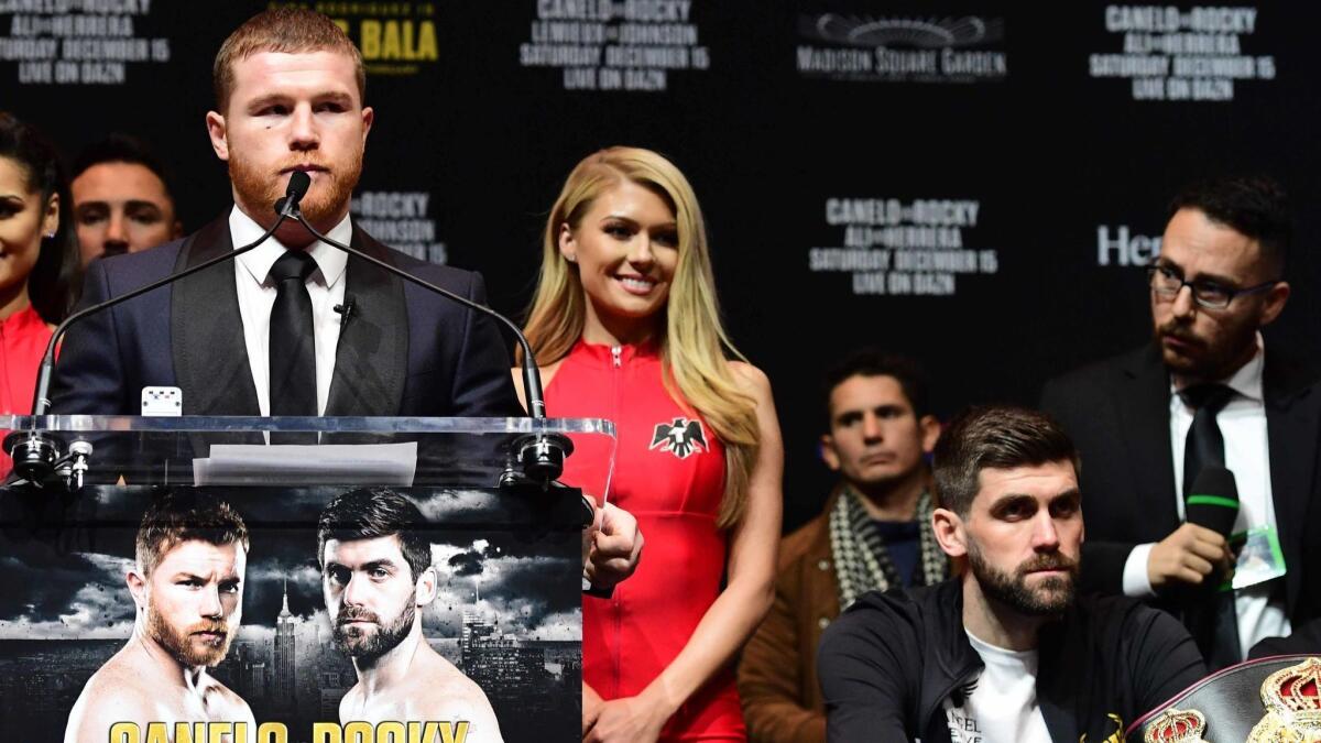 Canelo Alvarez speaks during a news conference while his Saturday opponent, Rocky Fielding, sits at right Dec. 13 at Madison Square Garden.
