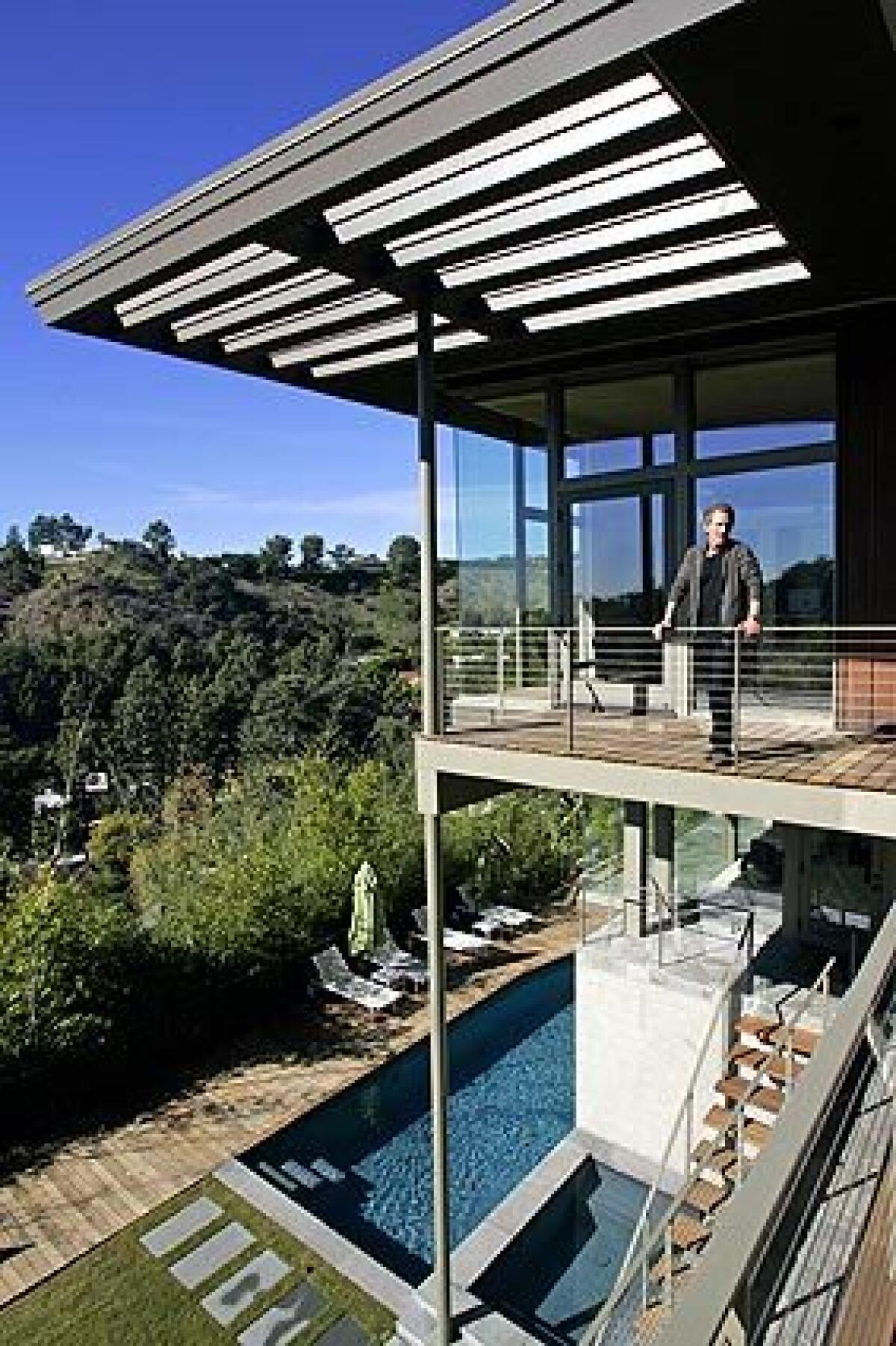 Greta Magnusson Grossman built this 1948 house in Beverly Hills as a quietly dramatic showcase of her skills as an architect and designer of interiors, furniture and lighting. Though she worked in the shadows of midcentury contemporaries such as Rudolph Schindler and Richard Neutra, Grossman maintains a following 10 years after her death — including designer Darryl Wilson, pictured, who bought the home three years ago and recently finished remodeling and expanding it with architect Tony Unruh. The goal: to reconcile the house's past with its future, modernizing it in a way that Grossman might have done herself.