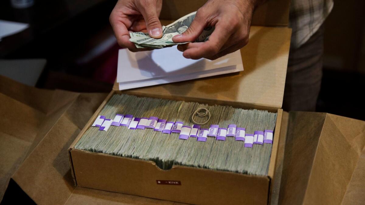 An owner of a medical marijuana dispensary in Los Angeles prepares his monthly tax payment on June 27.