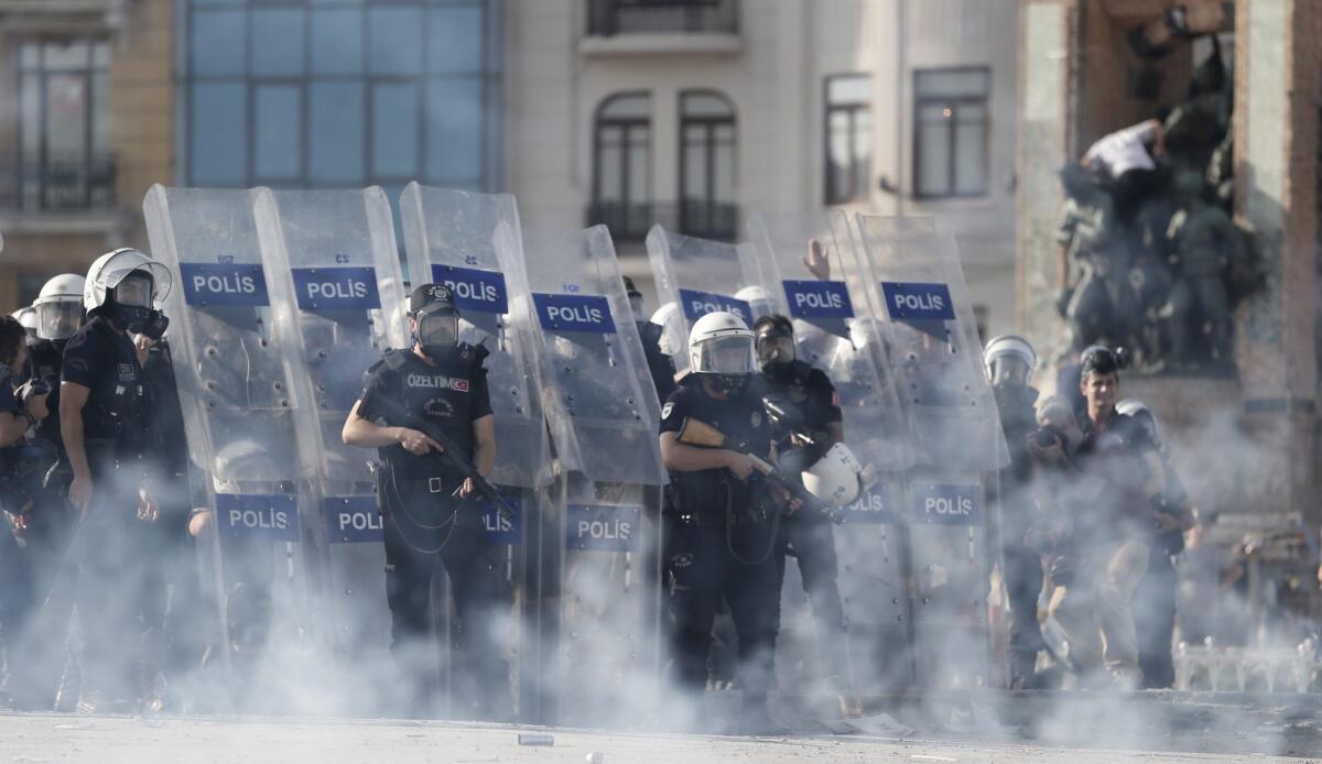 Police use tear gas and water cannons to disperse protesters during a clash at Taksim Square in Istanbul, Turkey.