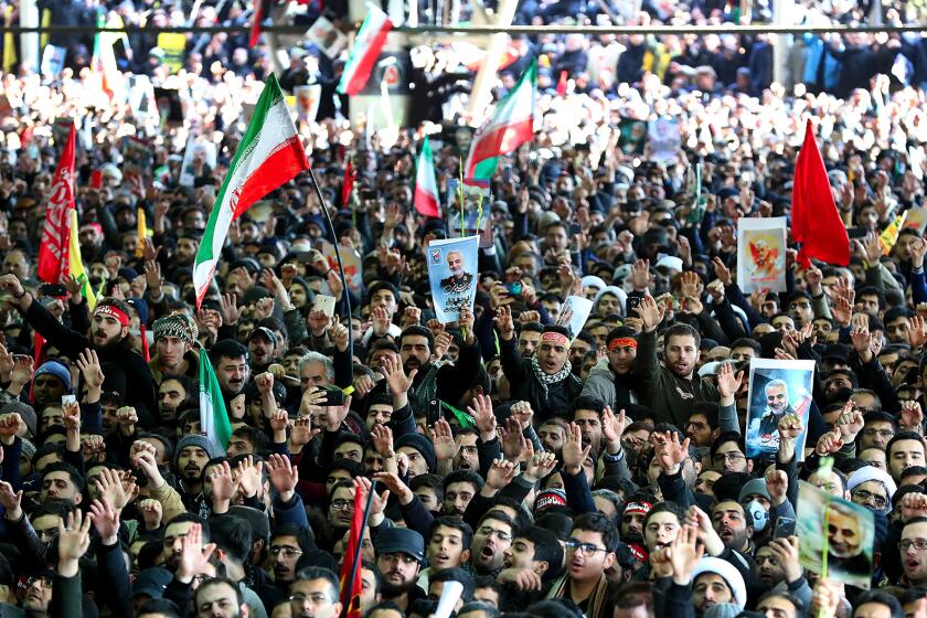 Iranian mourners carry a picture of Iran's Supreme Leader Ayatollah Ali Khamenei General Qasem Soleimani, during the funeral procession in the capital. Downtown Tehran, Iran was brought to a standstill on Jan. 6, 2020 as mourners flooded the Iranian capital to pay an emotional homage to Soleimani, the general who spearheaded Iran's Middle East operations as commander of the Revolutionary Guards' Quds Force and was killed in a US drone strike on Jan. 3 near Baghdad airport along with Iraqi paramilitary chief Abu Mahdi al-Muhandis and others. (SalamPix/ABACAPRESS.COM/TNS) ** OUTS - ELSENT, FPG, TCN - OUTS **