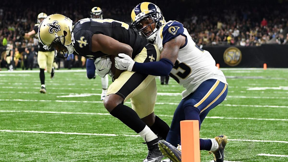 Saints receiver Michael Thomas drags Rams defensive back E.J. Gaines into the end zone for a touchdown on Sunday.
