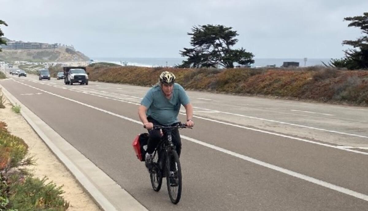 A cyclist rides on Carlsbad Boulevard just south of Avenida Encinas in 2021.