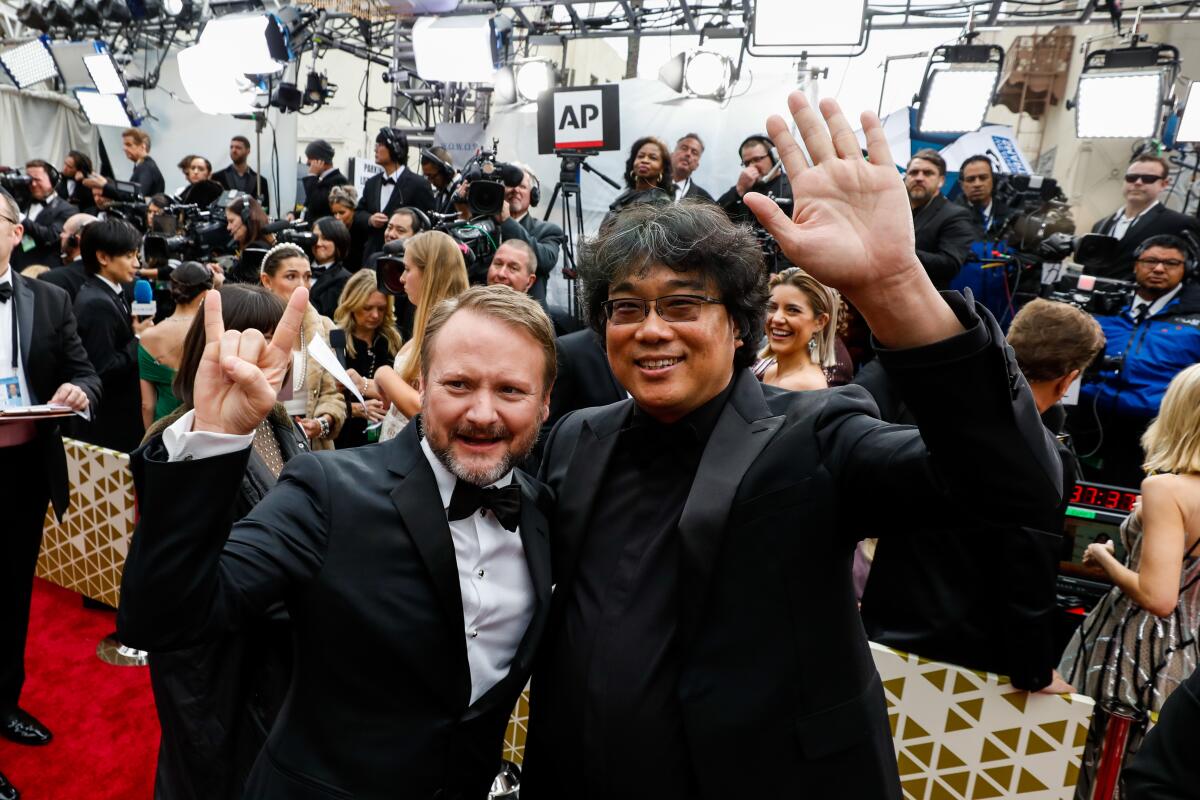 Rian Johnson, left, and Bong Joon Ho arriving at the 92nd Academy Awards.