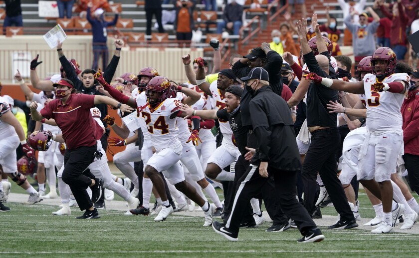 Iowa State players and coaches storm the field after their win over Texas in an NCAA college football game, Friday, Nov. 27, 2020, in Austin, Texas. (AP Photo/Eric Gay)