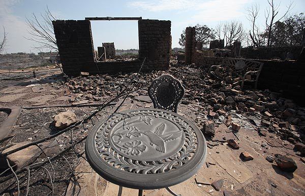 A table and chair is all that's left of a home destroyed by fire at Possum Kingdom Lake.