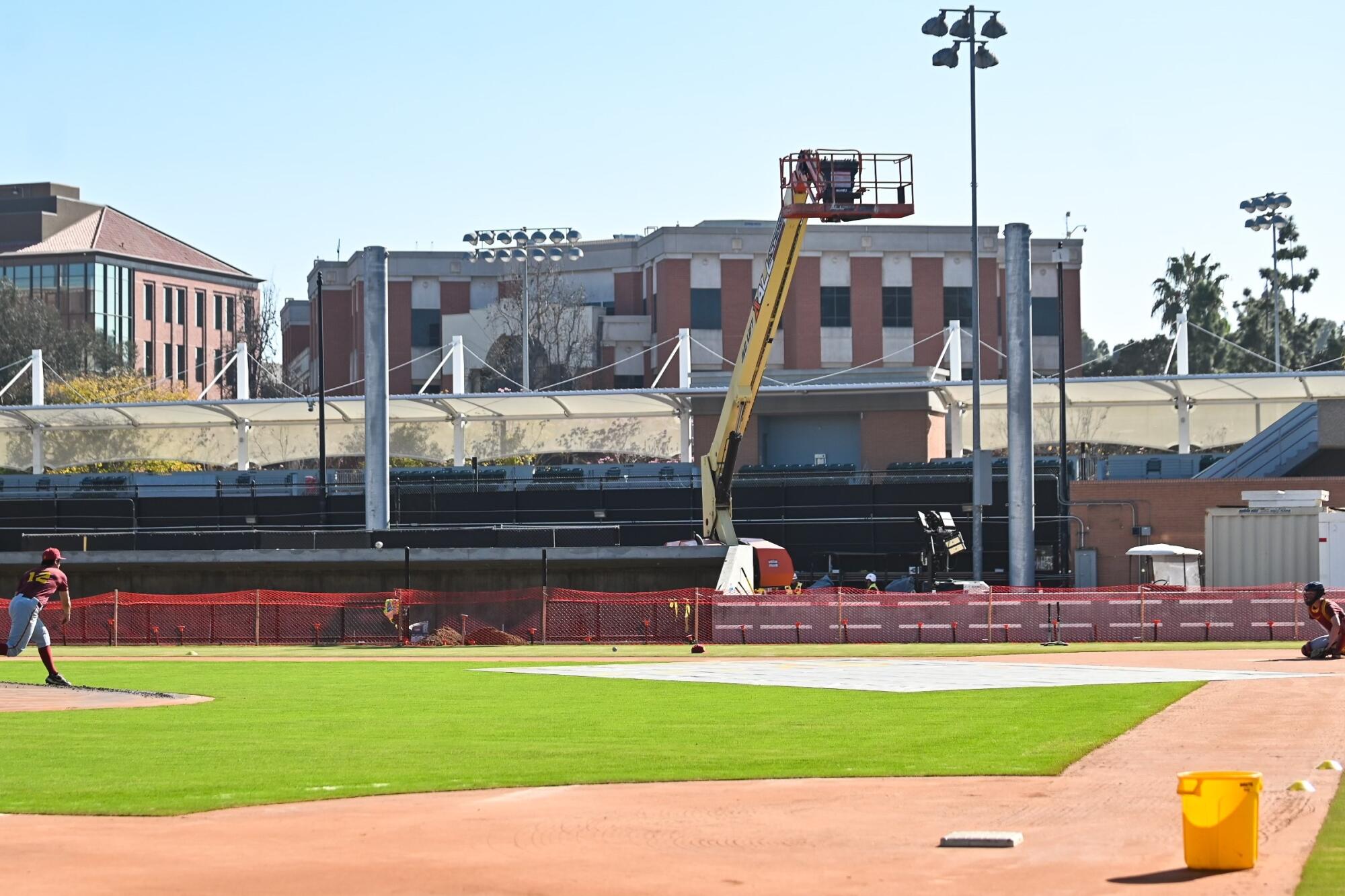 A USC pitcher and catcher work out on the new infield at Dedeaux Field.