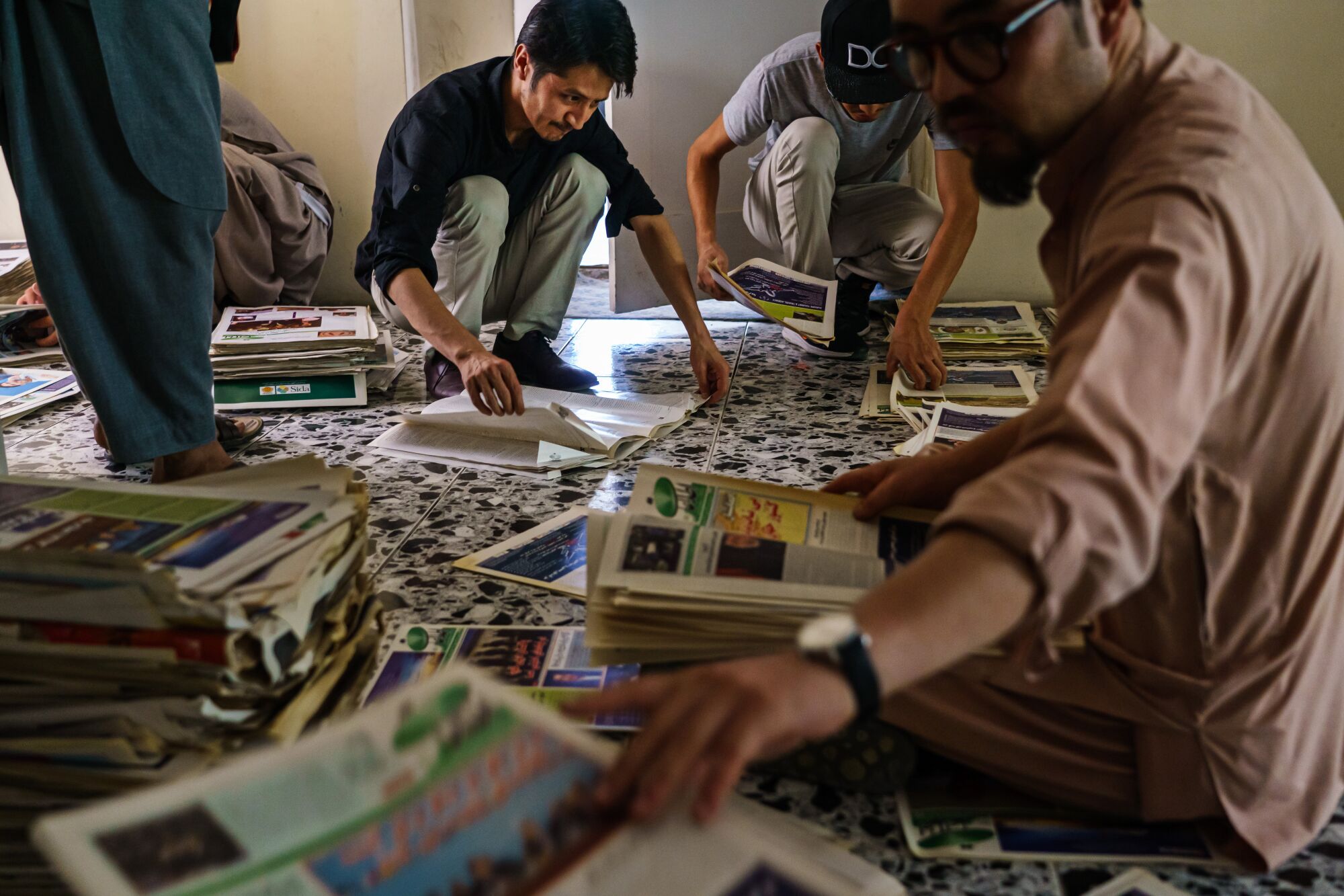 Zaki Daryabi and staff  pack up copies of their newspaper archives 