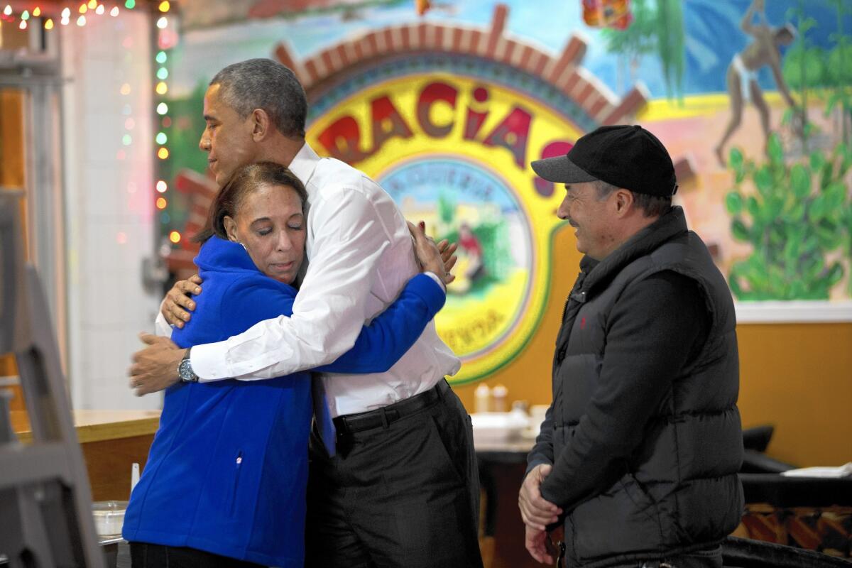 Lilia and Carlos Lepez welcome President Obama to their Nashville restaurant, La Hacienda. Both supporters and protesters demonstrated outside his speech at a nearby outreach center.