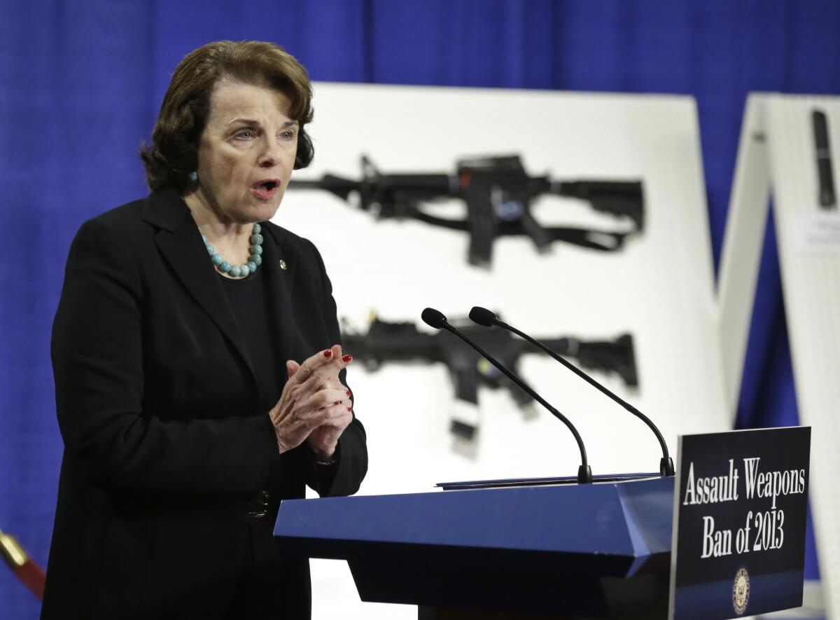 Dianne Feinstein speaking from a lectern that says "Assault Weapons Ban of 2013," in front of images of assault-style rifles.