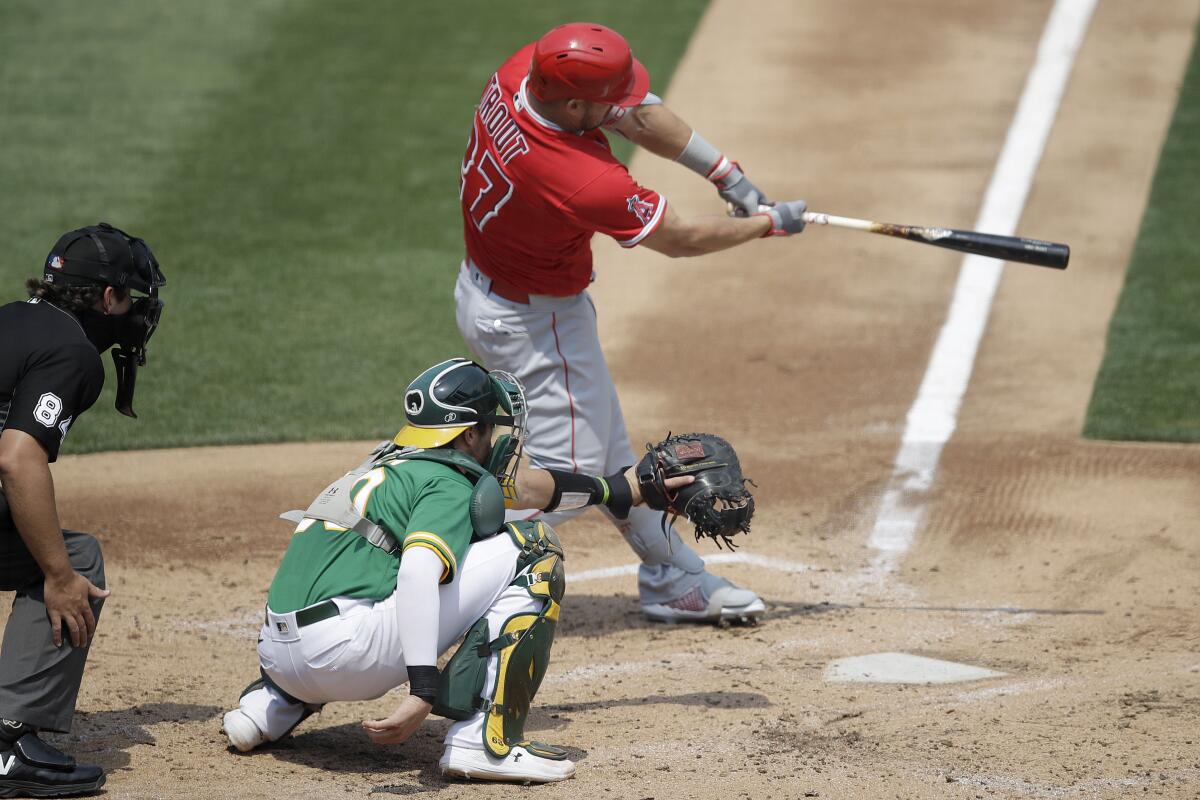 The Angels' Mike Trout connects for a two-run double in the second inning against the Athletics on Aug. 22, 2020.
