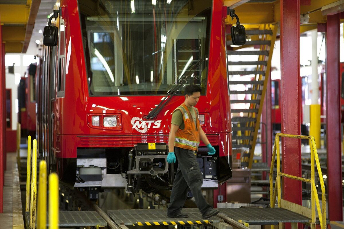 At the MTS trolley maintenance yard in downtown San Diego, Ron Parsario from Siemen works on one of the newest SD8 Short trolley trains recently added to the San Diego Metropolitan Transit System's fleet of trolleys.