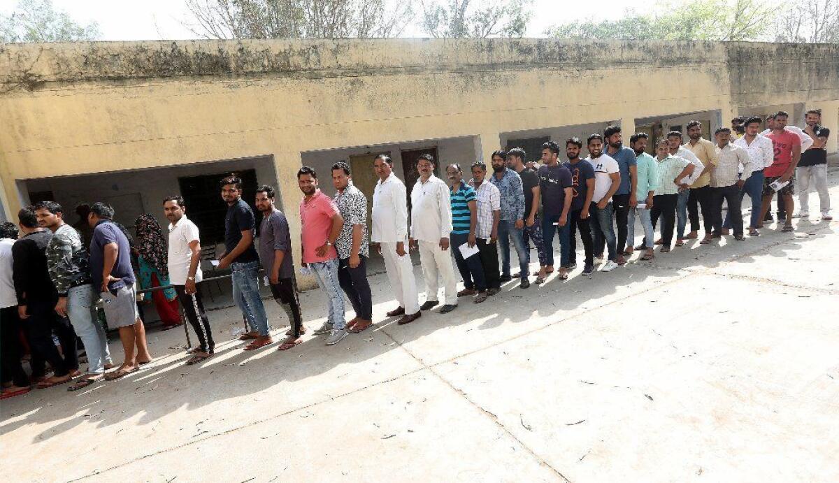 People line up to vote at a polling station in Dadri, in the northern state of Uttar Pradesh, as India begins multi-stage general elections on April 11.