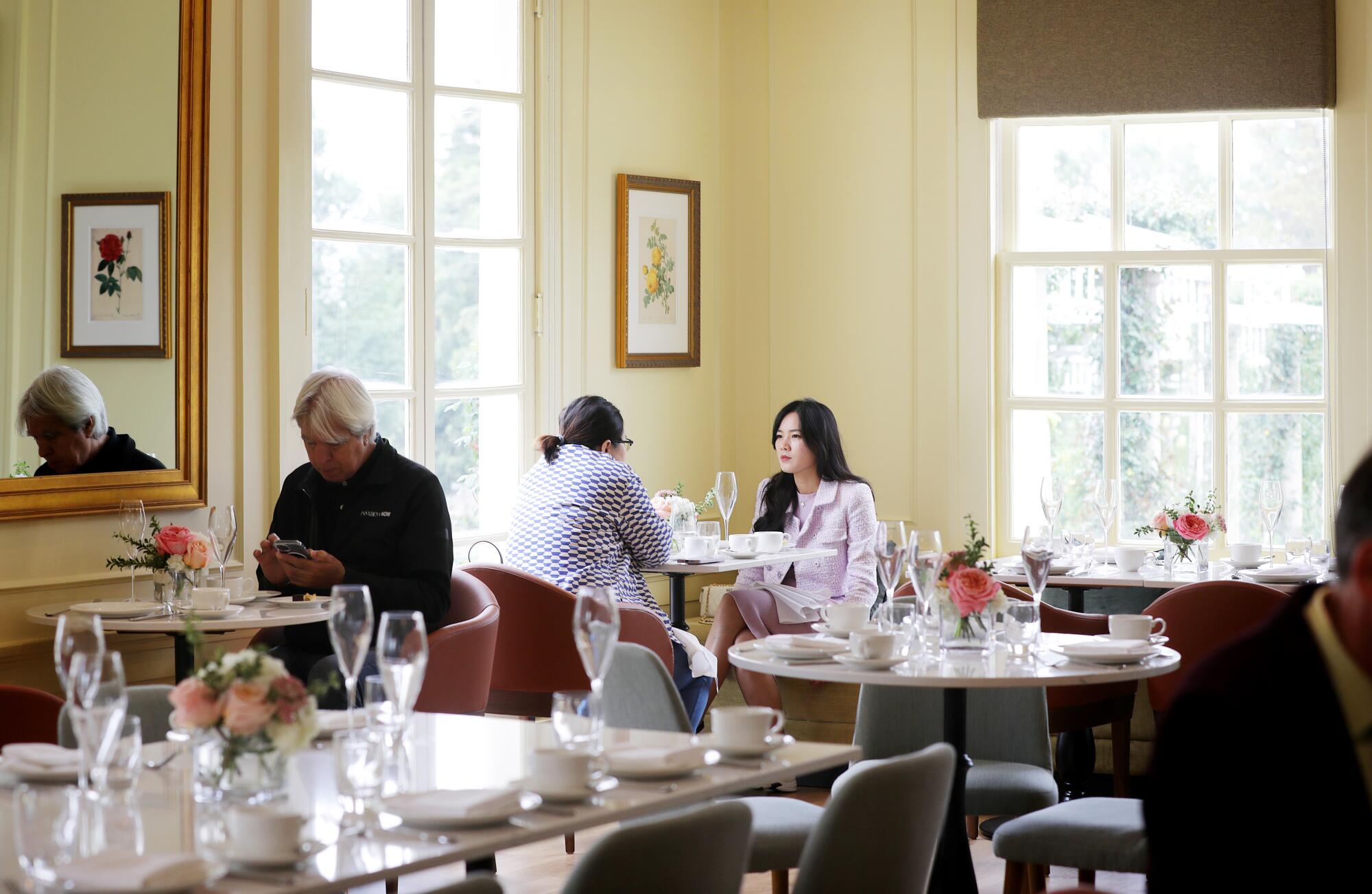 People sit in a sunny dining room in the Huntington's new Rose Garden Tea Room.