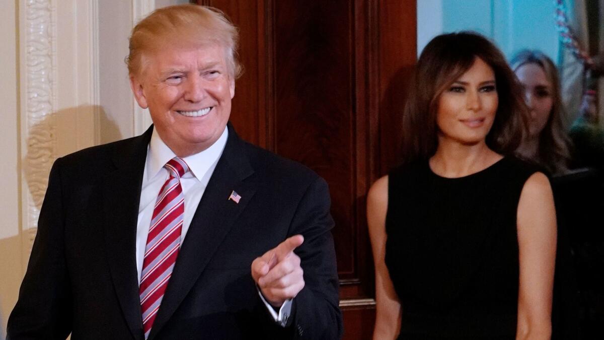 President Donald Trump and First Lady Melania Trump arrive for a National African American History Month reception in the East Room of the White House on Feb. 13.