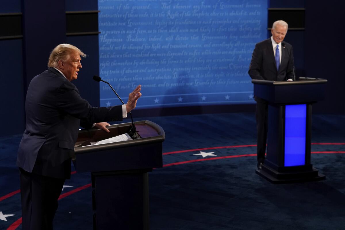 President Trump answers a question as Democratic challenger Joe Biden listens 