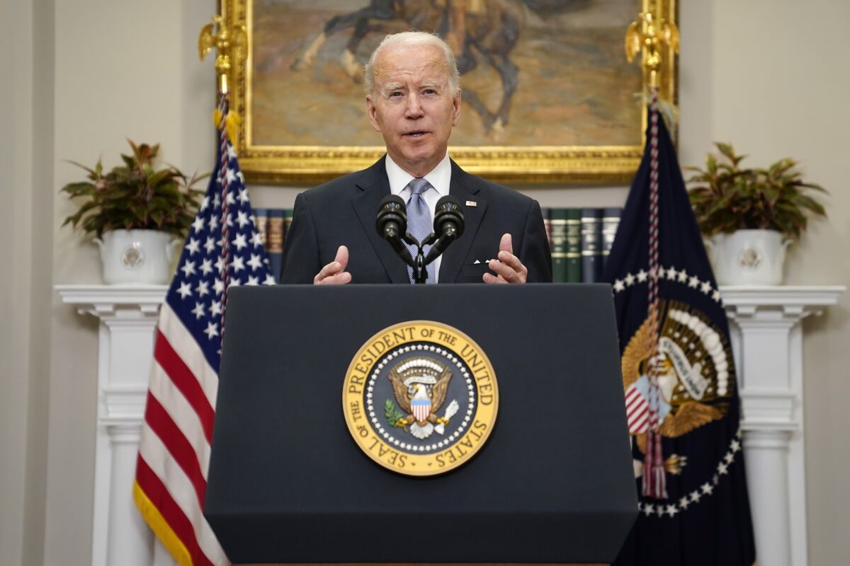 President Biden speaks at a lectern.