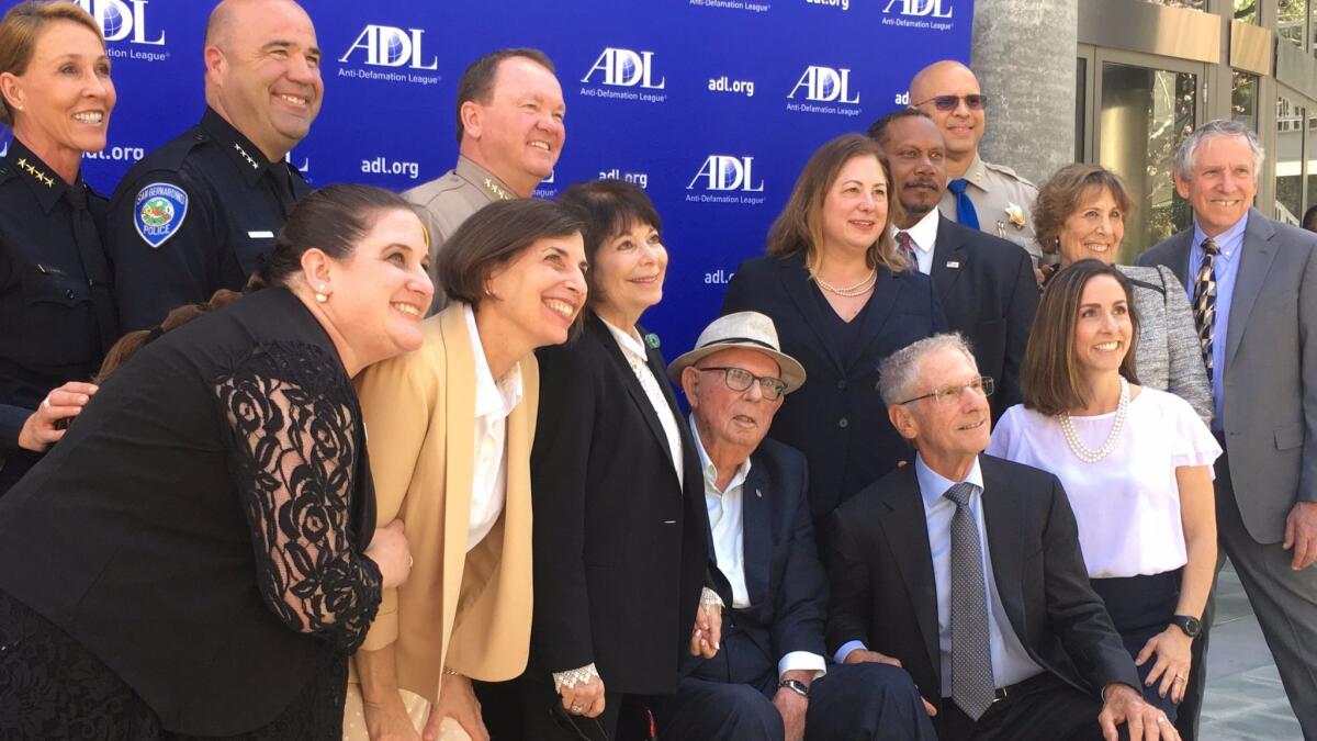 Southern California law enforcement leaders pose with Joseph Sherwood, 100, who created the Anti-Defamation League awards to honor law enforcement officials.